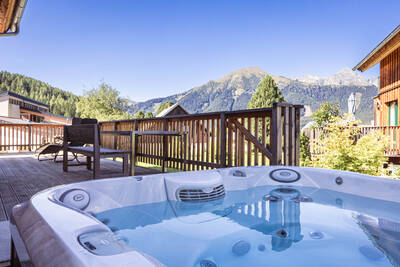 Holiday home with whirlpool on the veranda of a holiday home at Alps Resorts Almdorf Hohentauern