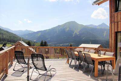 Veranda with mountain views from a holiday home at Alps Resorts Almdorf Hohentauern