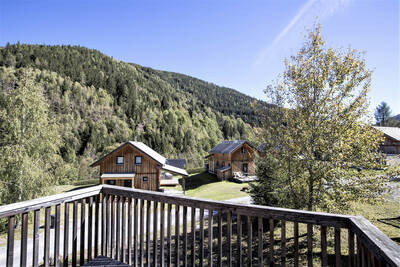 View over the mountains from a balcony of a chalet at Alps Resorts Almdorf Stadl