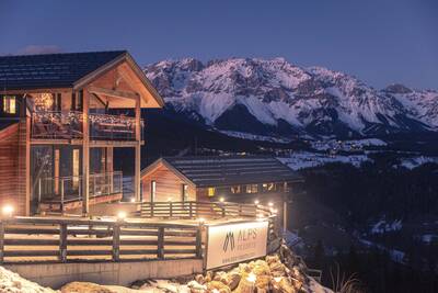 Detached chalet with mountains in the background at Alps Resorts Alpenchalets Reiteralm