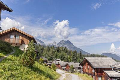 Chalets on a road at Alps Resorts Alpendorf Dachstein West