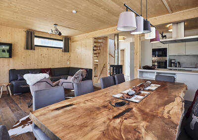 Living room with kitchen in a chalet at Alps Resorts Bergeralm Chalets