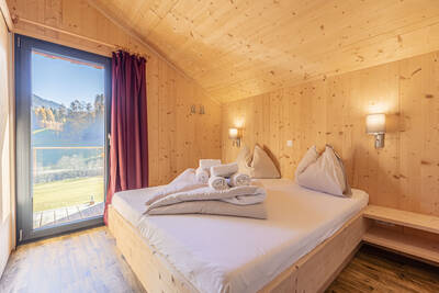 Bedroom with double bed and a chalet at Alps Resorts Bergeralm Chalets