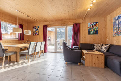 Living room with sliding door of a holiday home at Alps Resorts Feriendorf Murau