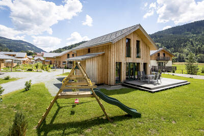 Small playground next to a holiday home at Alps Resorts Feriendorf Murau