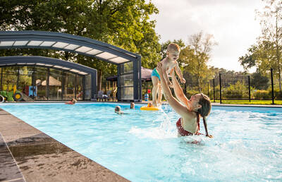 People swimming in the outdoor pool of Camping de Norgerberg