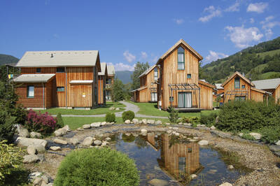 Holiday homes and a pond at FerienPark Kreischberg from Alps Resorts