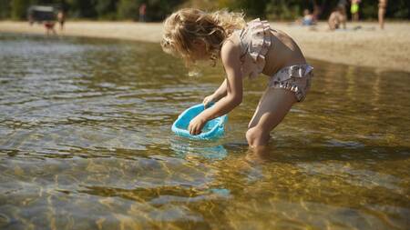 Girl playing in the swimming pond at Landal Estate Bourtange