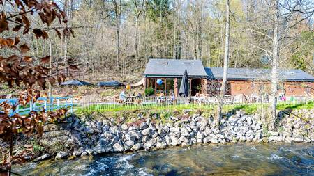 Terrace of the bar by the stream at the Landal Nature Parc Saint Hubert holiday park