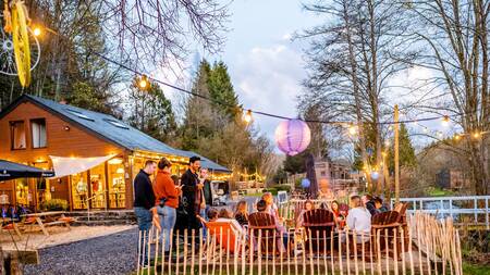 People on the terrace of the bar at the Landal Nature Parc Saint Hubert holiday park