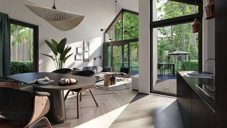 Living room with kitchen and dining table of a holiday home at the Landal Olde Kottink holiday park