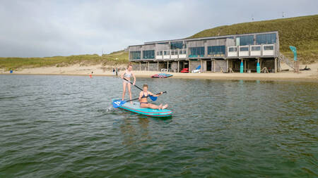 Children paddle boarding in the North Sea near Landal Residence Berger Duinen