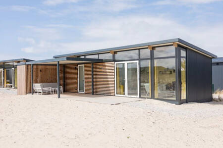 A holiday home with large windows at the Roompot Ameland holiday park